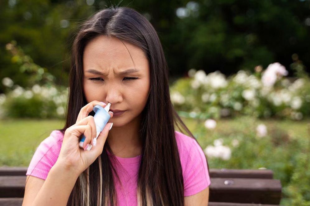 woman-using-nasal-spray-front-view